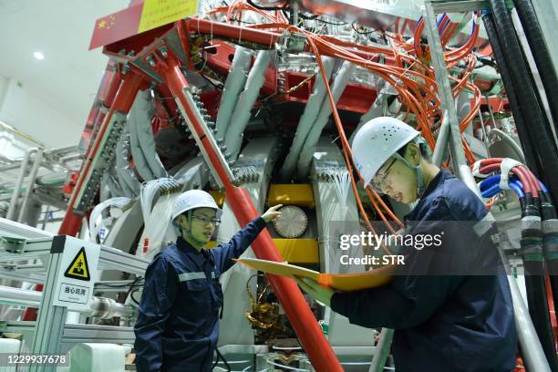 Technical personnel checks the Chinas HL-2M nuclear fusion device, known as the new generation of "artificial sun", at a research laboratory in...