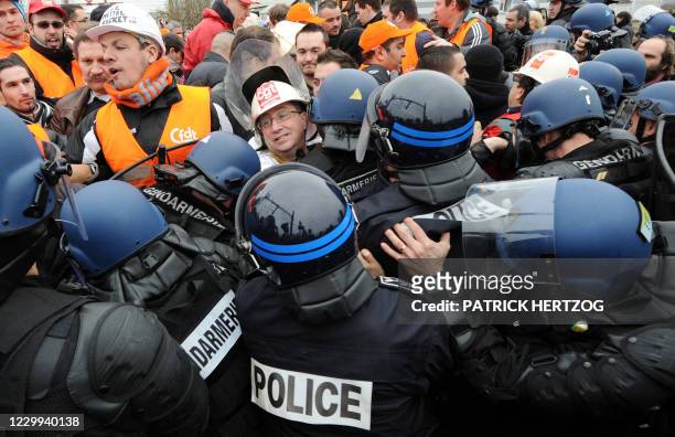 French gendarmes evacuate Florange's workers of the world's biggest steelmaker Indian ArcelorMittal who block the railway of the TGV on March 2, 2012...