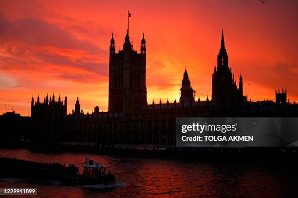 The sun sets behind the Palace of Westminster, the home of the Houses of Parliament in central London on December 4 as talks continue in London on a...