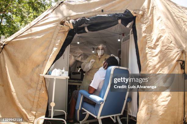 Health worker performs a COVID-19 testing at the Emergency Care Unit Colubandê on December 4, 2020 in Sao Goncalo, Brazil. The State Department of...