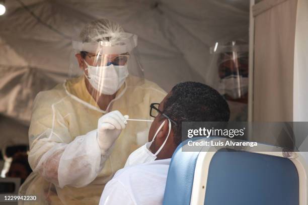 Health worker performs a COVID-19 testing at the Emergency Care Unit Colubandê on December 4, 2020 in Sao Goncalo, Brazil. The State Department of...