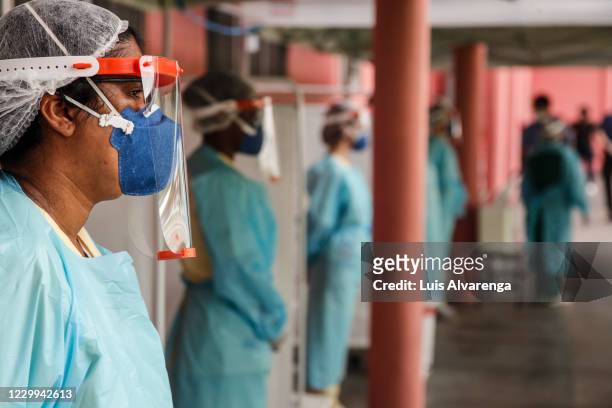 Health workers from the Alberto Torres hospital wearing PPE wait to perform COVID-19 testings on December 4, 2020 in Sao Goncalo, Brazil. The State...