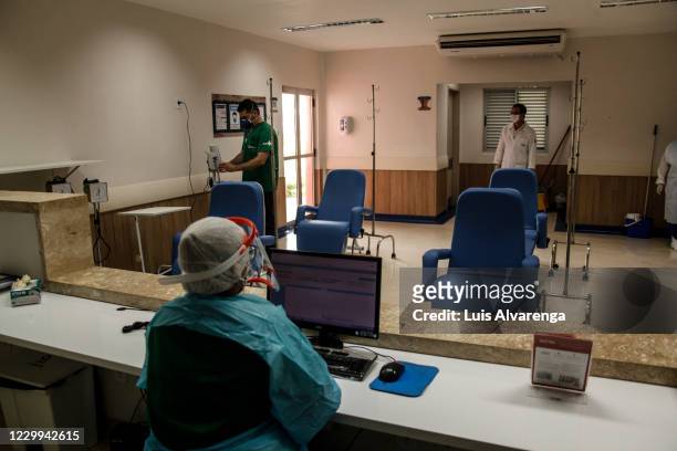 Health workers from the Alberto Torres hospital wearing PPE prepare to perform COVID-19 testings on December 4, 2020 in Sao Goncalo, Brazil. The...