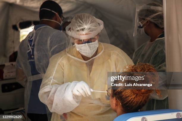 Health worker performs a COVID-19 testing at the Emergency Care Unit Colubandê on December 4, 2020 in Sao Goncalo, Brazil. The State Department of...