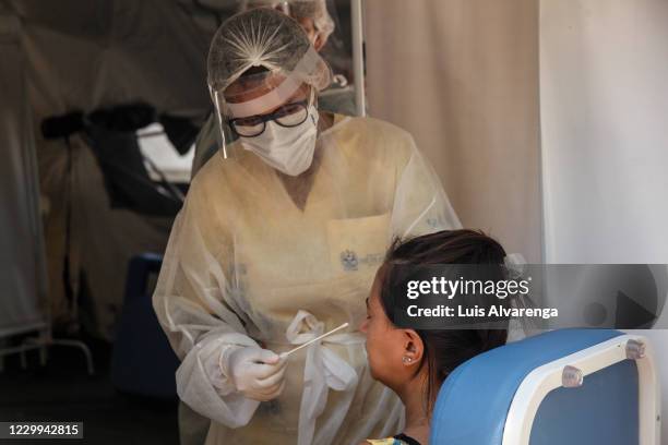 Health worker performs a COVID-19 testing at the Emergency Care Unit Colubandê on December 4, 2020 in Sao Goncalo, Brazil. The State Department of...