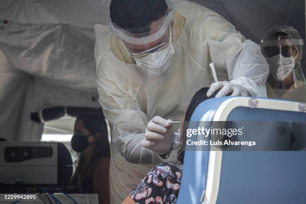 Health worker performs a COVID-19 testing at the Emergency Care Unit Colubandê on December 4, 2020 in Sao Goncalo, Brazil. The State Department of...