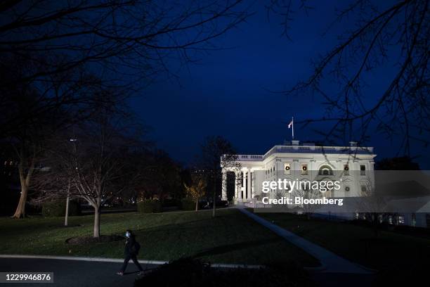 The White House at night in Washington, D.C., U.S., on Friday, Dec. 4, 2020. Prospects for a pandemic relief package before the end of the year grew...