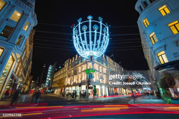 Christmas lights illuminate New Bond Street near the Fenwick department store as people enjoy a night of shopping days after the end of the second...