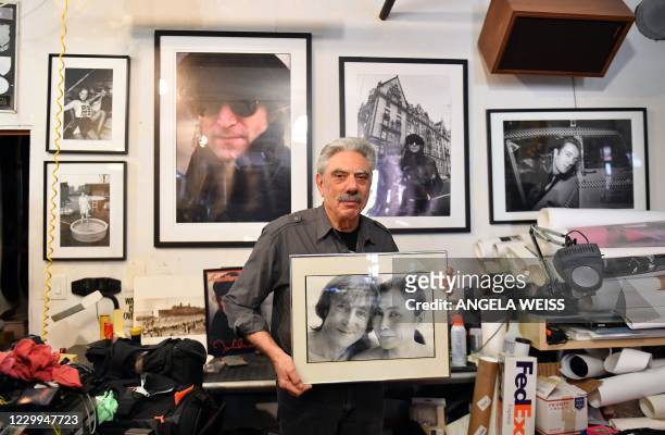 Photographer Allan Tannenbaum poses with his photographs of John Lennon and Yoko Ono in his SoHo studio on December 3 in New York City. - Tannenbaum,...
