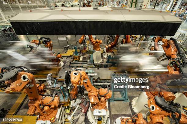 Robotic arms operate on the Nio Inc. Electric vehicle assembly line during a media tour in Hefei, Anhui province, China, on Friday, Dec. 4,...