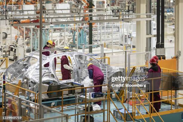 Employees assemble a vehicle during a media tour of the Nio Inc. Production facility in Hefei, Anhui province, China, on Friday, Dec. 4, 2020. Nio is...