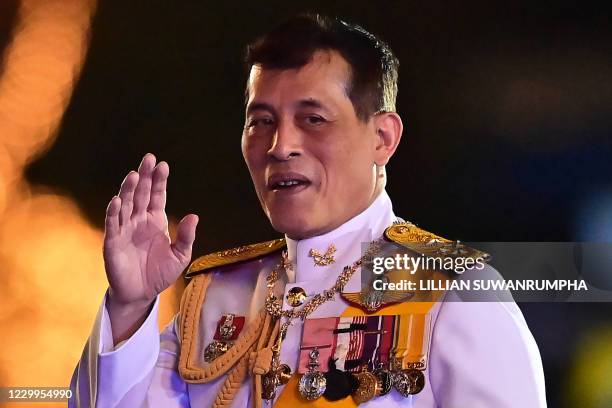 Thailand's King Maha Vajiralongkorn waves to royalist supporters during a ceremony to commemorate the birthday of the late Thai king Bhumibol...