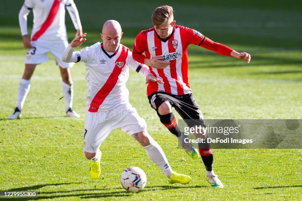Isaac Palazon of Rayo Vallecano and Mateusz Bogusz of UD Logrones battle for the ball during the La Liga SmartBank match between Rayo Vallecano and...