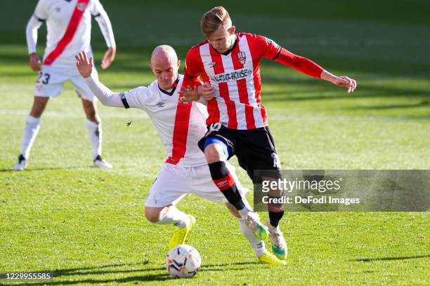 Isaac Palazon of Rayo Vallecano and Mateusz Bogusz of UD Logrones battle for the ball during the La Liga SmartBank match between Rayo Vallecano and...
