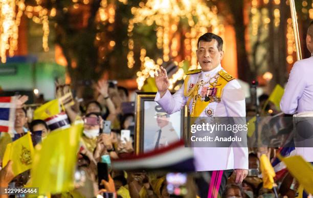 Thailand King Maha Vajiralongkorn waves to royalist supporters at Sanam Luang in front of the Grand Palace during a ceremony to mark the birthday of...