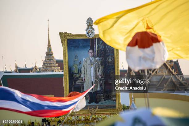 Large portrait of late Thai King Bhumibol Adulyadej at Sanam Luang in front of the Grand Palace during a ceremony to mark the birthday of the late...