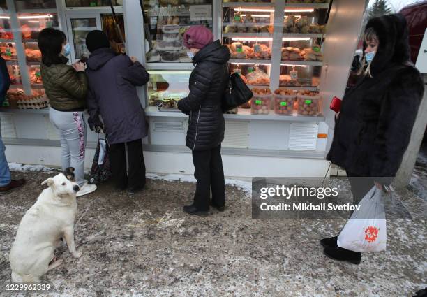 Women queue at a butcher shop, on December 5, 2020 in Staritsa, located on the Volga river, 250 kilometers northwest from Moscow, in Tver oblast,...