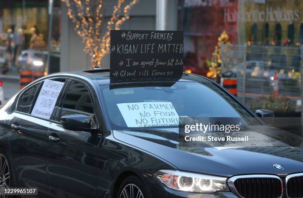 Convoy of vehicles drive along Bloor Street in front of the Indian consulate in support of farmers protesting in India. In Toronto. December 5, 2020....