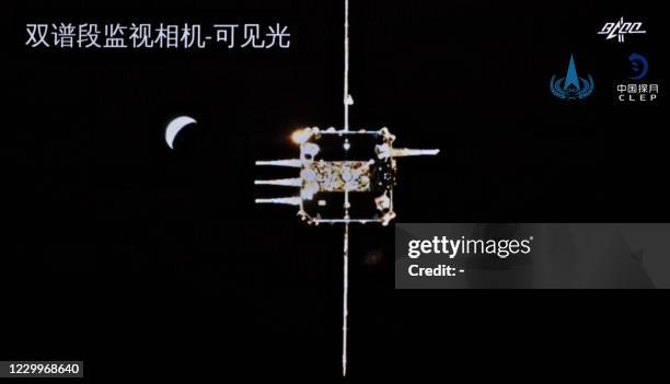 This picture taken and released on December 6, 2020 by the China National Space Administration via CNS shows the orbiter of China's Chang'e-5 lunar...