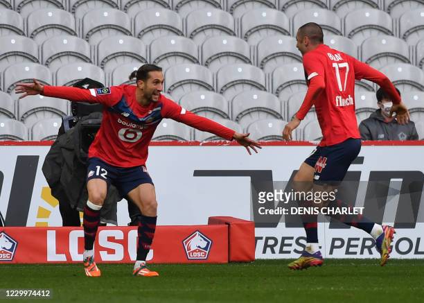 Lille's Turkish miedfielder Yusuf Yazici and Lille's forward Burak Yilmaz jubilate after scoring a goal during the French L1 football match between...