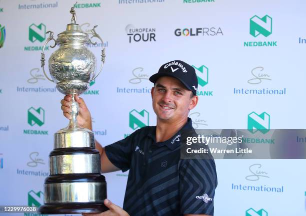 Christiaan Bezuidenhout of South Africa holds the the trophy after his victory during the final round of the South African Open at Gary Player CC on...