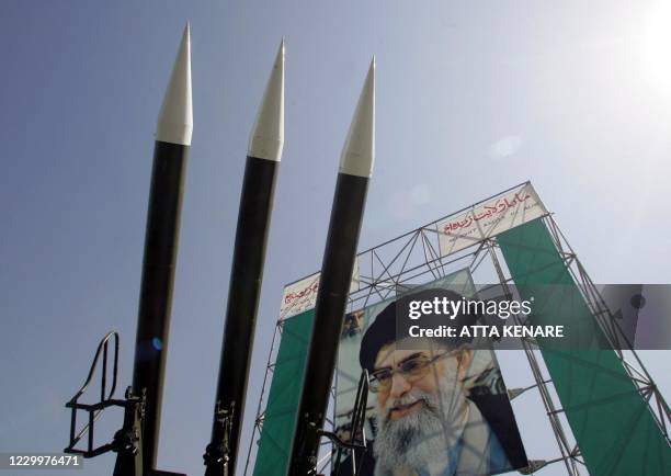Russian-made Sam-6 surface-to-air missiles are seen in front of a portrait of Iran's Supreme Leader Ayatollah Ali Khamenei at a war exhibition to...