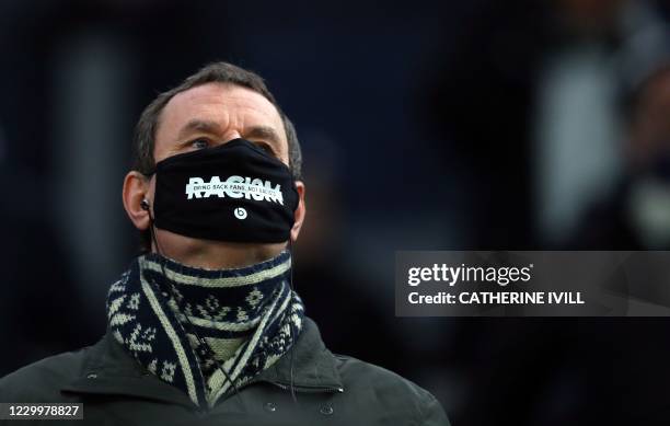 Tottenham supporter wears an anti racism face mask before the English Premier League football match between Tottenham Hotspur and Arsenal at...