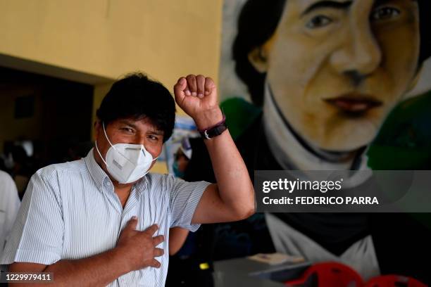 Bolivian ex-president Evo Morales wearing face mask, gestures during a visit to a polling station in downtown Caracas, on December 6 during...