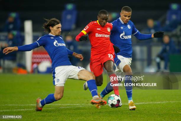 Leverkusen's French forward Moussa Diaby , Schalke's French midfielder Benjamin Stambouli and Schalke's Finnish midfielder Malick Thiaw vie for the...