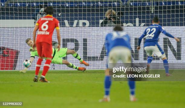 Schalke's German forward Steven Skrzybski has his penalty saved by Leverkusen's Finnish goalkeeper Lukas Hradecky during the German first division...