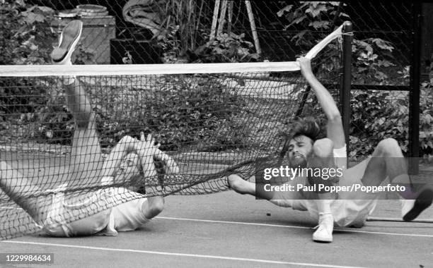 The Bee Gees' Barry Gibb and Maurice Gibb taking a tumble on the tennis court during the filming of "Cucumber Castle", a comedy film written and...