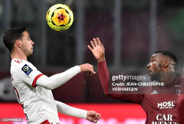 Lyon's Italian defender Mattia de Sciglio fights for the ball with Metz's French forward Thierry Ambrose during the French L1 football match between...