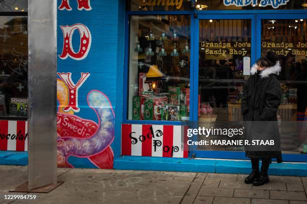 Woman observes a monolith that was erected out front of Grandpa Joes Candy Shop in the Strip District area of Pittsburgh, Pennsylvania on December 6,...