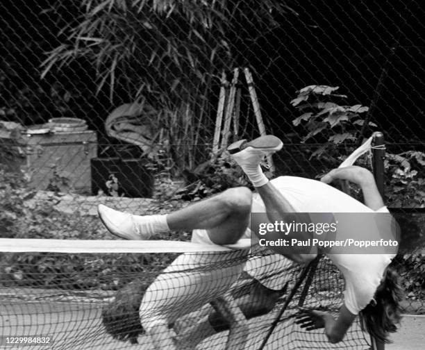 The Bee Gees' Barry Gibb and Maurice Gibb taking a tumble on the tennis court during the filming of "Cucumber Castle", a comedy film written and...