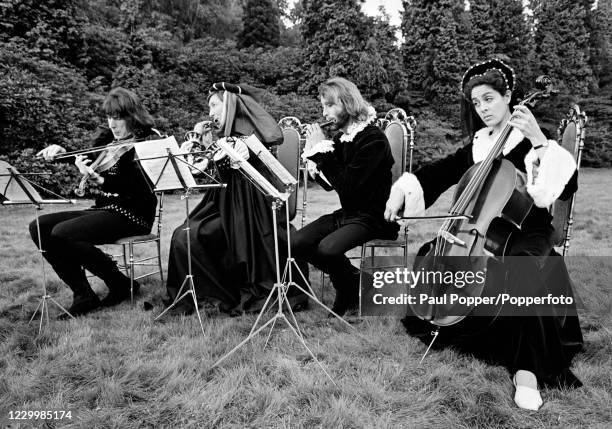 Julian Orchard, Pat Coombs, Maurice Gibb and Eleanor Bron during the filming of "Cucumber Castle", a comedy film written and produced by The Bee Gees...