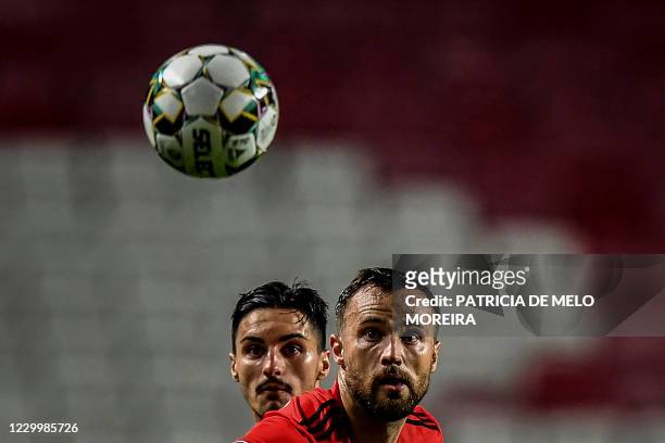 Benfica's Swiss forward Haris Seferovic and Pacos de Ferreira's Canadian midfielder Stephen Eustaquio eye the ball during the Portuguese League...