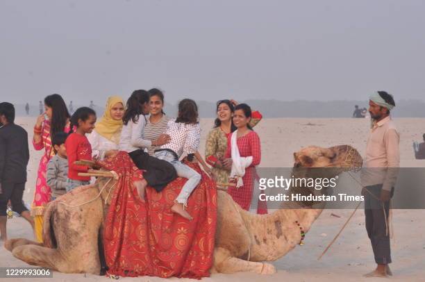 People seen riding a camel at Masi, on December 6, 2020 in Varanasi, India.