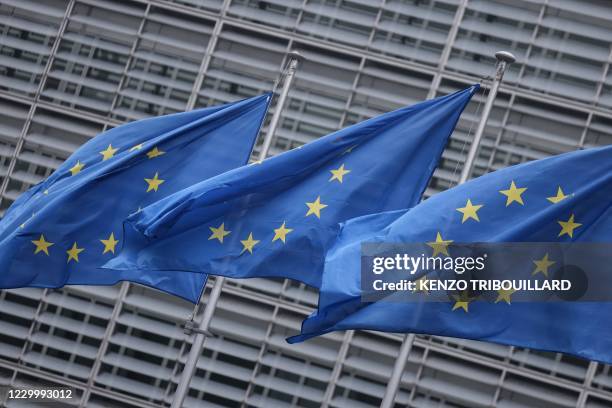 European Union flags fly outside the European Commission building in Brussels, on December 7, 2020.