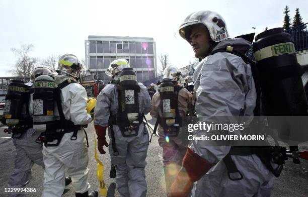 Firemen inspect the area after an explosion at the chemical university in Mulhouse, eastern France, 24 March 2006. One person was killed and another...