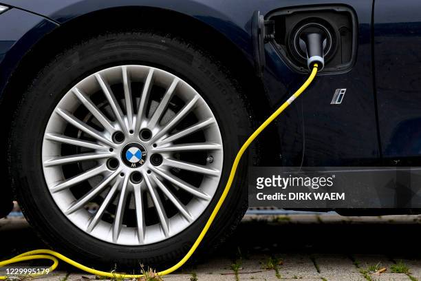 Illustration picture shows a plug-in hybrid BMW car with electricity charger, Monday 07 December 2020 in Bornem. BELGA PHOTO DIRK WAEM