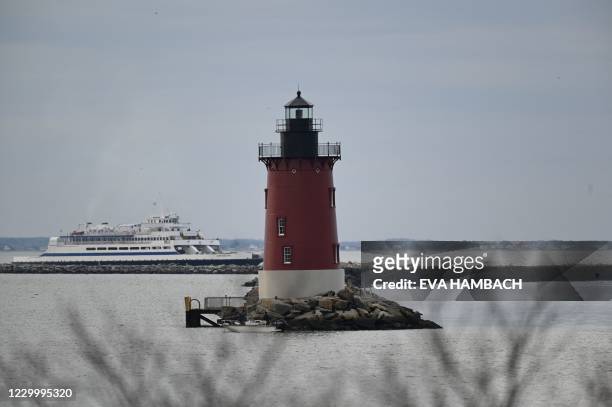 The ferry between Lewes, Delaware and Cape May, New Jersey, passes the Breakwater Lighthouse, established in 1885, seen from the shores of Cape...