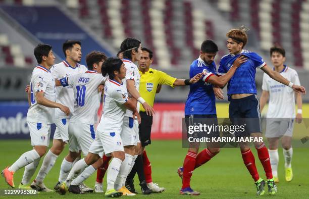 Sri Lankan referee Hettikamkanamge Perera seperates players during a disagreement in the AFC Champions League round of 16 football match between...