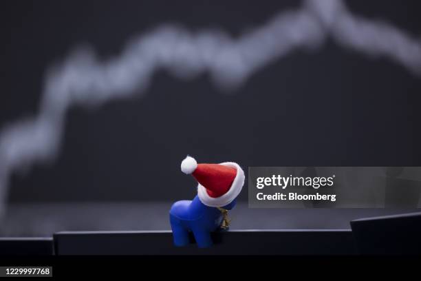 Festive toy bull decorates a trader's desk monitor near theDAX Index yield curve at the Frankfurt Stock Exchange, operated by Deutsche Boerse AG, in...