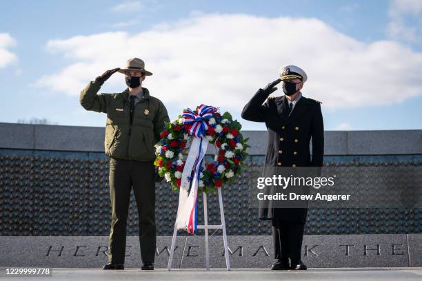 National Park Service ranger Sam Yancho and National Park Service Living History volunteer Sidney Wade salute during a wreath-laying ceremony to mark...