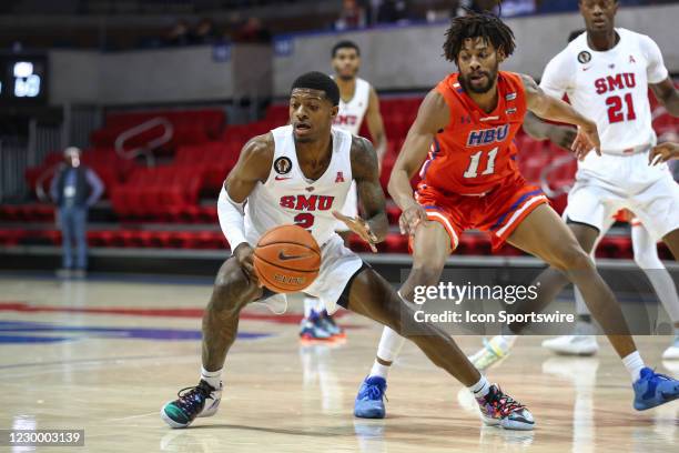 Mustangs guard Darius McNeill dribbles the ball as Houston Baptist Huskies forward Jason Thompson defends during the college basketball game between...