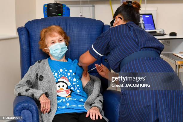 Nurse May Parsons administers the Pfizer/BioNtech Covid-19 vaccine to Margaret Keenan at University Hospital in Coventry, central England, on...