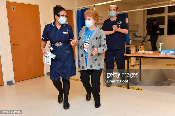 Margaret Keenan walks with nurse May Parsons after becoming the first patient in the United Kingdom to receive the Pfizer/BioNtech covid-19 vaccine...