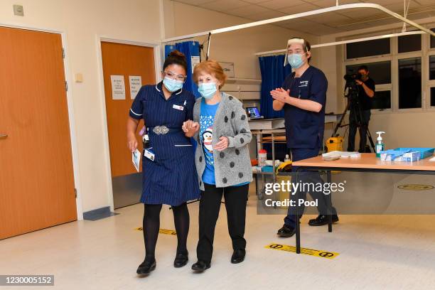 Margaret Keenan walks with nurse May Parsons after becoming the first patient in the United Kingdom to receive the Pfizer/BioNtech covid-19 vaccine...