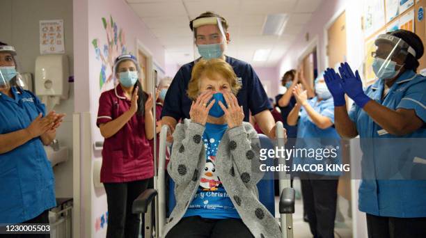 Margaret Keenan is applauded by staff as she returns to her ward after becoming the first person to receive the Pfizer-BioNtech Covid-19 vaccine at...