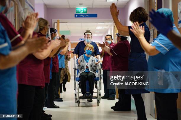Margaret Keenan is applauded by staff as she returns to her ward after becoming the first person to receive the Pfizer-BioNtech Covid-19 vaccine at...